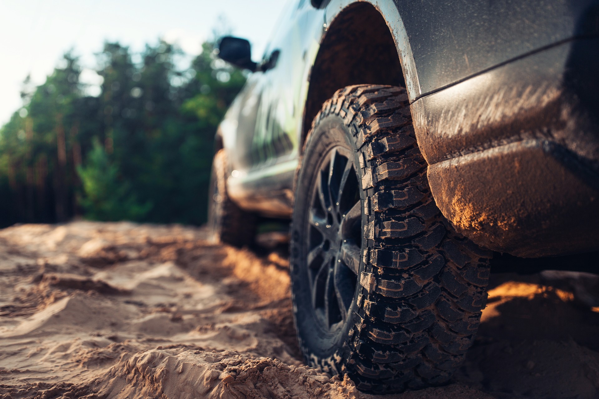 SUV car at the off road close up view of the wheel